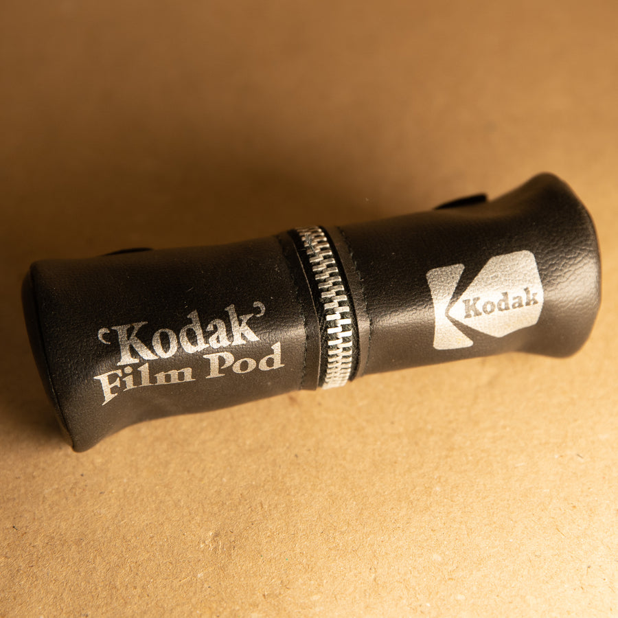 Kodak film pod for carrying 35mm film canisters on camera strap