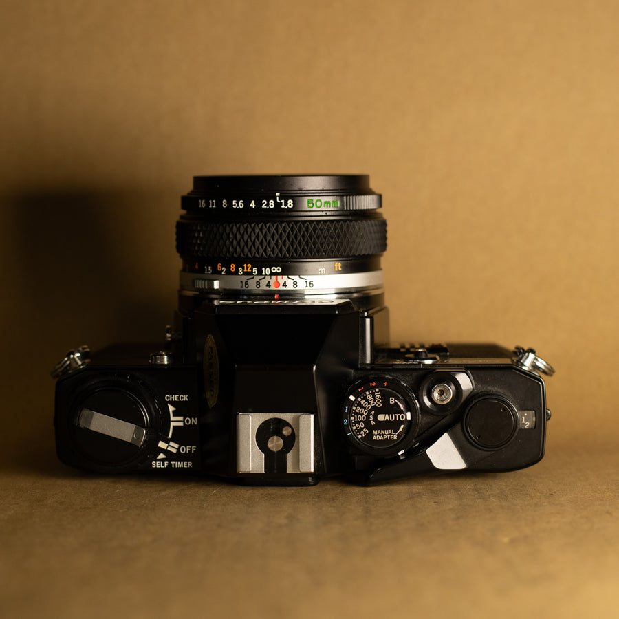 Olympus OM10 negra con lente de 50 mm f/1.8