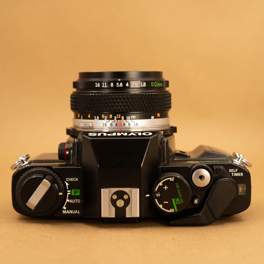 Olympus OM40 Program in Black with 50mm f/1.8 Lens – Cameras By