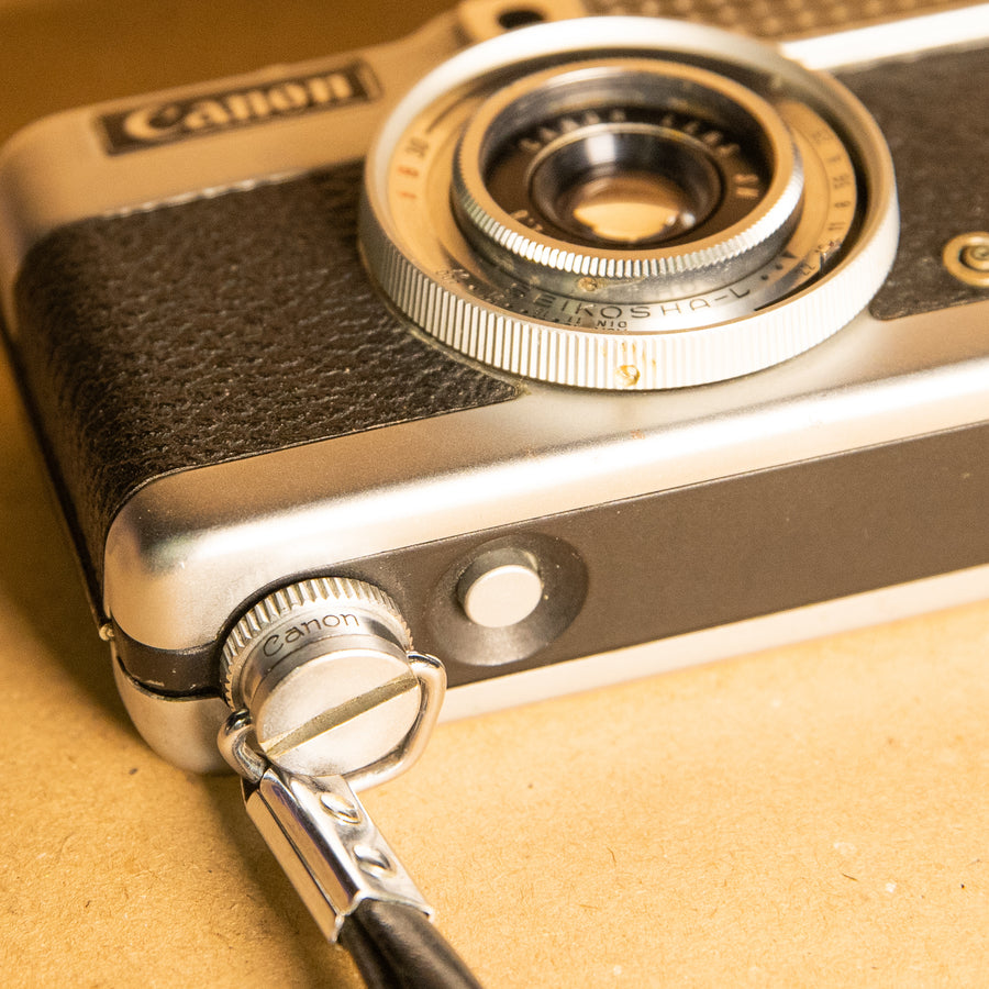 Canon wrist strap screws into tripod mount for 35mm film cameras