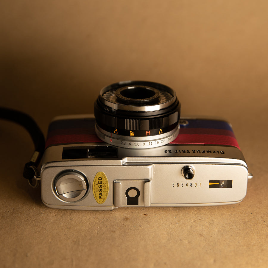 Bi Flag Olympus Trip 35mm film camera with roll of film